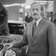 A black and white photo of Lotus founder Colin Chapman in his factory in North London.